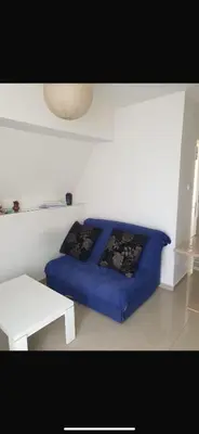 a bedroom with a blue bed and a white table at Apartman- Ledine in Ledine