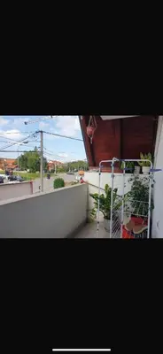 a balcony with a bed and plants on a building at Apartman- Ledine in Ledine