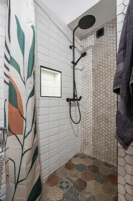 a bathroom with a shower with a glass door at Black & White Delight in Belgrade