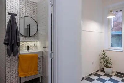 a bathroom with a sink and a mirror at Black & White Delight in Belgrade