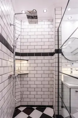a white tiled bathroom with a shower and a sink at Elegant, Chique & Spacious Boho Loft in Belgrade