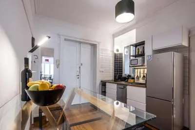 a kitchen with a bowl of fruit on a glass table at Elegant, Chique & Spacious Boho Loft in Belgrade