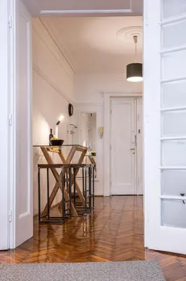 a kitchen with a wooden table in the middle of a room at Elegant, Chique & Spacious Boho Loft in Belgrade