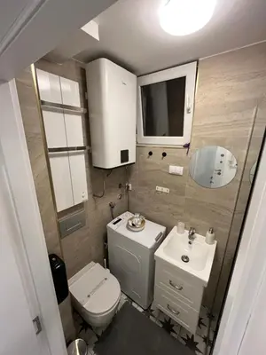 a small bathroom with a toilet and a sink at Studio Ramonda - City Center Dorcol - with Free Parking in Belgrade