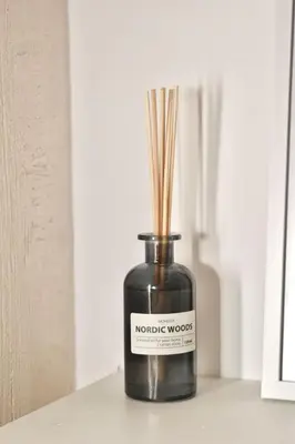 a black bottle with sticks in it on a table at Studio Ramonda - City Center Dorcol - with Free Parking in Belgrade