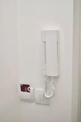 a white phone is hanging on a wall at Studio Ramonda - City Center Dorcol - with Free Parking in Belgrade