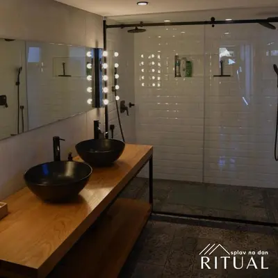 two sinks on a counter in a bathroom with a shower at Ritual splav in Belgrade