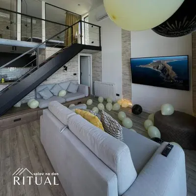 a living room with a couch and a staircase at Ritual splav in Belgrade