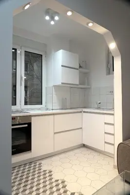 a kitchen with white cabinets and a tile floor at Heart of Belgrade in Belgrade