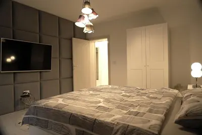 a bedroom with a bed and a flat screen tv at Heart of Belgrade in Belgrade