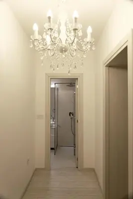 a chandelier in a room with a hallway at Heart of Belgrade in Belgrade