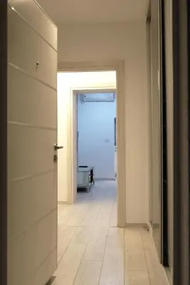 a hallway with a door leading to a room with a floor at Heart of Belgrade in Belgrade