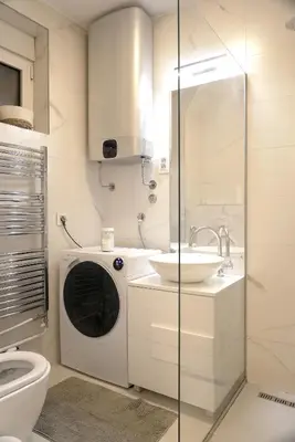 a bathroom with a washing machine and a sink at Heart of Belgrade in Belgrade