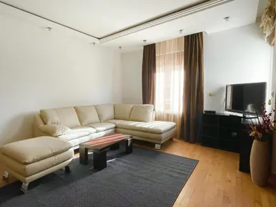 a living room with a couch and a tv at Ninis city flat in Belgrade