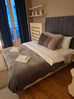 a bedroom with a large bed with two towels on it at Dečanska studio in Belgrade
