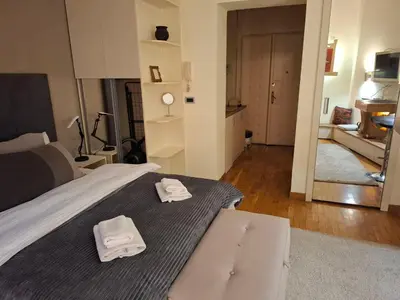 a bedroom with a bed with two towels on it at Dečanska studio in Belgrade