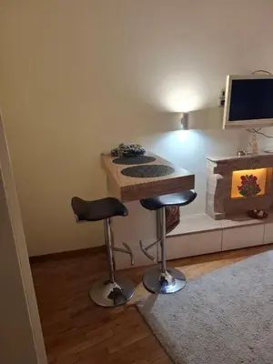 a room with a desk with a computer and a stool at Dečanska studio in Belgrade