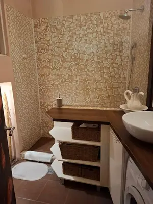 a bathroom with a sink and a counter with a toilet at Dečanska studio in Belgrade