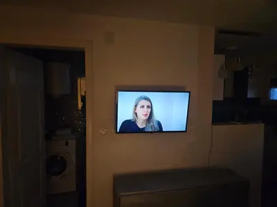 a television on a wall in a room at Apartman Helena 2 in Lazarevac