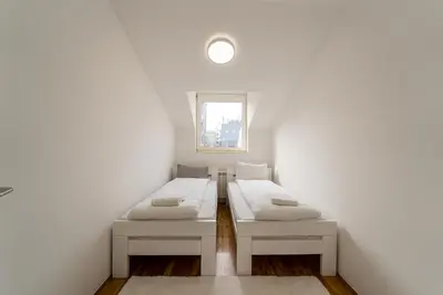 a room with two beds and a window at Spacious Family Apartment in Belgrade