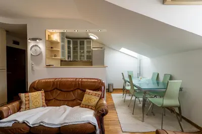 a living room with a couch and a table at Spacious Family Apartment in Belgrade