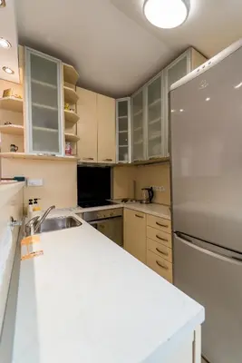 a kitchen with a white counter and a refrigerator at Spacious Family Apartment in Belgrade