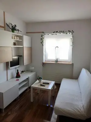 a small room with a bed and a table at Small low cost studio Dorcol in Belgrade
