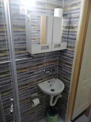 a bathroom with a sink and a mirror at Small low cost studio Dorcol in Belgrade