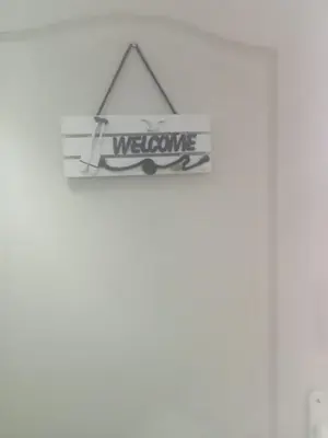 a welcome sign is hanging on a wall at Small low cost Dorcol in Belgrade