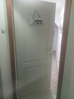 a white door with a sign on it in a hallway at Small low cost Dorcol in Belgrade