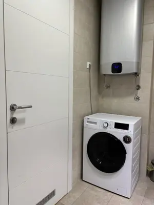 a washer and dryer in a kitchen with a cabinet at Exing Prime 65 New Belgrade in Belgrade