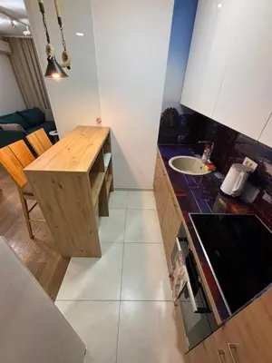 a kitchen with a wooden table and a sink at Exing Prime 65 New Belgrade in Belgrade