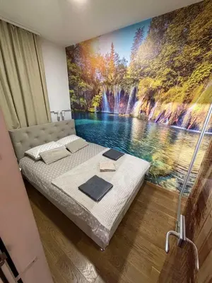 a bedroom with a waterfall mural on the wall at Exing Prime 65 New Belgrade in Belgrade