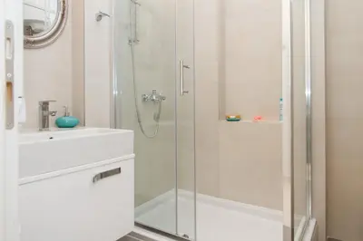 a bathroom with a glass shower and a sink at Center 2BDR additional living Room King bed 4 pers in Belgrade