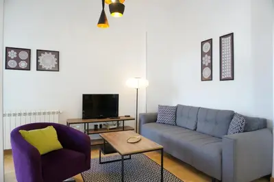 a living room with a couch and a chair at Center 2BDR additional living Room King bed 4 pers in Belgrade