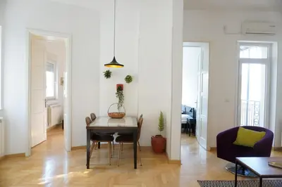 a living room with a table and a couch at Center 2BDR additional living Room King bed 4 pers in Belgrade