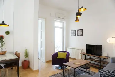 a living room with a couch and a table at Center 2BDR additional living Room King bed 4 pers in Belgrade