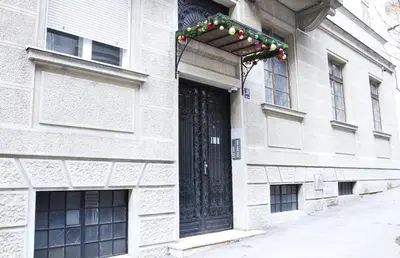 a building with a black door with christmas lights at Crown Apartment - Your Royal Stay in Belgrade