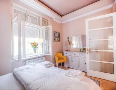 a bedroom with a bed and a window at Crown Apartment - Your Royal Stay in Belgrade
