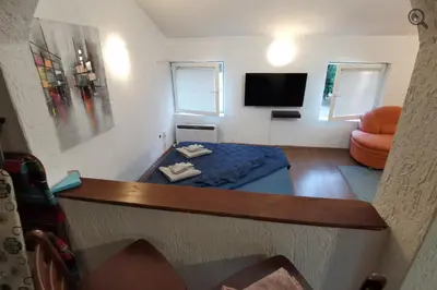 a small living room with a couch and a tv at Konza1 in Belgrade