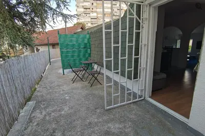a patio with a table and chairs and a fence at Konza1 in Belgrade