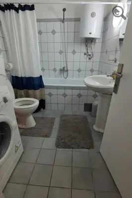 a bathroom with a toilet and a sink and a shower at Konza1 in Belgrade