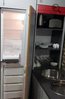 a small kitchen with a sink and an open refrigerator at Konza 2 in Belgrade