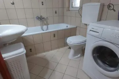 a bathroom with a toilet and a washing machine at Konza 2 in Belgrade