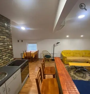a kitchen and living room with a yellow couch at Konza 2 in Belgrade