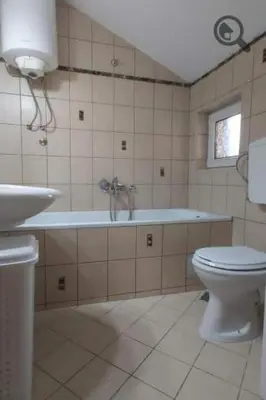 a bathroom with a toilet and a tub and a sink at Konza 2 in Belgrade