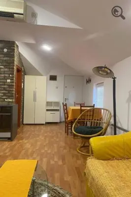 a living room with a table and a kitchen at Konza 2 in Belgrade