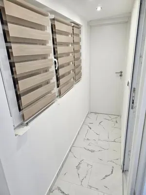 a bathroom with white walls and marble floors and a window at Rabit delux I in Belgrade