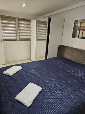 a bedroom with a blue bed with towels on it at Rabit delux I in Belgrade