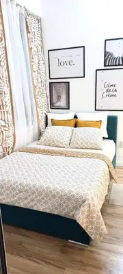 a bedroom with a bed with a headboard at Rooms & Apartments Miavik in Belgrade